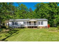 Well-maintained single-story home with charming front porch and wheelchair ramp access surrounded by lush trees at 1060 Sierra Rd, York, SC 29745