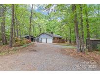 Charming ranch-style home with a two-car garage, nestled in a serene, wooded lot at 111 Pine Grove Church Rd, Concord, NC 28025
