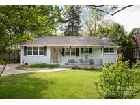 Charming single story home featuring a well manicured lawn, covered entry, and inviting walkway to the front door at 1120 E. Woodlawn Rd, Charlotte, NC 28209