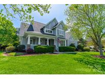 Charming gray two-story home with a welcoming front porch and lush green lawn at 125 Swayne Dr, Mooresville, NC 28117