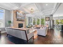 Spacious living room featuring a stone fireplace, coffered ceilings, and an open floor plan at 164 Riverstone Dr, Davidson, NC 28036