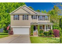 Charming two-story home features a two-car garage and a beautifully landscaped front yard at 3040 Sunshower Hts, York, SC 29745
