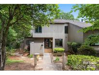 Two-story townhome with wood siding, a walkway to the front door, and mature landscaping at 58 Ridgeport Rd, Clover, SC 29710