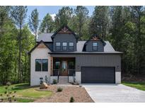 Charming two-story home featuring a modern facade, lush landscaping, and inviting front entrance at 6265 Riviera Run Estates Dr, Hickory, NC 28601