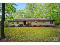 Charming single-story home with lush landscaping and inviting curb appeal at 109 Canterbury Ln, Matthews, NC 28104