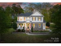 Charming two-story home featuring stone accents, manicured lawn, and inviting front porch at 139 Autumn Grove Ln, Mooresville, NC 28115
