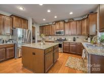 This spacious kitchen boasts an island, stainless steel appliances, and granite countertops, perfect for cooking and entertaining at 139 Autumn Grove Ln, Mooresville, NC 28115