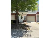 Charming townhouse featuring a brick facade and a welcoming front door with a decorative wreath at 14208 Castle Abbey Ln, Charlotte, NC 28277