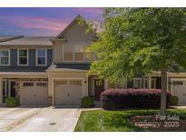 Charming townhome with a one-car garage, well-maintained lawn, and mature landscaping at 226 Scenic View Ln, Matthews, NC 28104