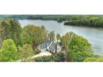 Stunning aerial view of lakeside home with lush greenery and a private, serene setting at 272 Harbor Ridge Dr, Statesville, NC 28677