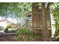 Cozy back deck with brick chimney and mature landscaping offers a serene outdoor living space at 5769 Birch St, Conover, NC 28613