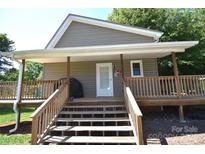 This home boasts a welcoming covered porch with wooden steps and railings, perfect for enjoying the outdoors at 5769 Birch St, Conover, NC 28613