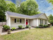 Charming single-story home featuring a cozy front porch and well-maintained landscaping at 7820 Elm Tree Ln, Charlotte, NC 28227