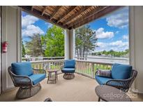 Inviting balcony with comfortable seating and scenic lake views, perfect for relaxing and entertaining at 7822 Village Harbor Dr, Cornelius, NC 28031