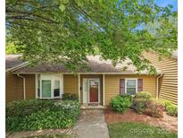 Charming single-story home with mature landscaping, inviting curb appeal, and a warm, welcoming entrance at 8322 Summerglen Cir, Charlotte, NC 28227