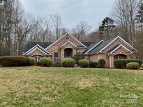 Charming single-story brick home with well-manicured landscaping and inviting curb appeal at 9113 Oak Bluff Ct, Waxhaw, NC 28173