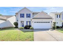 Charming two-story home featuring blue shutters, landscaped yard, and a two-car garage at 17546 Westmill Ln, Charlotte, NC 28277