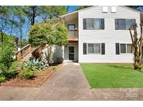 Traditional two-story home featuring a well-maintained lawn, mature trees and neutral exterior siding at 1773 Hunters Trl, Rock Hill, SC 29732