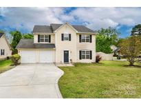 Charming two-story home with a two-car garage, well-maintained lawn, and a classic design at 225 Carrie Ct, Concord, NC 28027