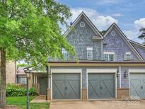Charming home featuring a two-car garage, and shingle siding, set in a lush, landscaped neighborhood at 2616 Colton Dr, Charlotte, NC 28211