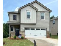 Charming two-story home with a two-car garage and manicured lawn at 291 Bezelle Ave, York, SC 29745