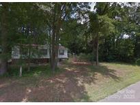 Modest single-story home nestled among mature trees, needs some TLC at 433 E Geroid St, Salisbury, NC 28144