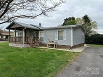 Charming single-story home with a covered porch and well-maintained lawn at 51 Kings Dr, Taylorsville, NC 28681