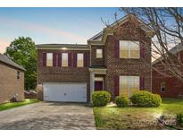 Beautiful two-story brick home with a two-car garage and manicured lawn at 620 Millstream Dr, Rock Hill, SC 29732