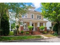 Charming two-story home with a inviting front porch and manicured landscaping at 10102 Tolleson Ave, Charlotte, NC 28277