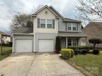 Charming two-story home with a two-car garage, well-maintained lawn, and manicured bushes at 1110 Valley St, Statesville, NC 28677