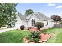 Charming single-story home with manicured lawn, beautiful landscaping and lovely curb appeal at 141 Rose St, Mooresville, NC 28117