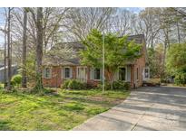 Charming brick home featuring a well-maintained lawn, mature trees, and inviting curb appeal at 1620 Edgefield Ave, Gastonia, NC 28052
