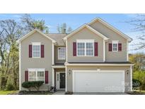 Charming two-story home featuring a two-car garage, neutral siding, and attractive red shutters at 2120 Turtle Point Rd, Charlotte, NC 28262