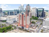 Stunning aerial view of uptown building in vibrant city with surrounding skyscrapers, parking, and green spaces at 222 S Caldwell St # 1510, Charlotte, NC 28202