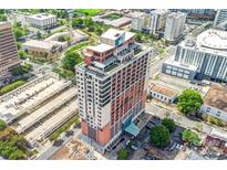 Expansive aerial view of a tall building in an urban environment with surrounding greenery at 222 S Caldwell St # 1510, Charlotte, NC 28202