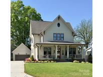 Charming two-story home with a inviting front porch, lush lawn and a detached garage in the back at 2309 Pinckney Ave, Charlotte, NC 28205