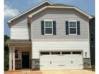 Charming two-story home featuring a white garage door and a stylish gray-and-white exterior at 277 Bezelle Ave, York, SC 29745