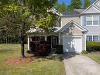 Charming home with an attached garage, a porch, and well-maintained landscaping at 6846 Beverly Springs Dr, Charlotte, NC 28270