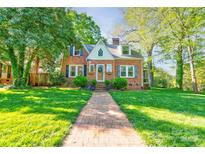 Charming brick home with manicured lawn and inviting brick walkway at 902 Hawthorne Rd, Shelby, NC 28150