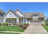 Charming single-Gathering home with a two-car garage, well-manicured lawn, and inviting front porch at 10378 Ambercrest Nw Ct, Huntersville, NC 28078