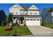 Beautiful two-story home with well-maintained lawn and attached two-car garage at 1077 Hearth Sw Ln, Concord, NC 28025