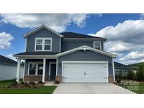 Charming two-story home featuring a two-car garage, blue siding, and manicured lawn at 1240 Morehead Dr, Salisbury, NC 28144