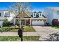 Charming single-Gathering home featuring a well-manicured front yard and a classic American mailbox at 152 Blossom Ridge Dr, Mooresville, NC 28117
