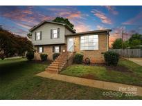 Charming two-story home with brick and vinyl siding, complemented by a well-manicured lawn and landscaped yard at 1766 Colony Rd, Rock Hill, SC 29730