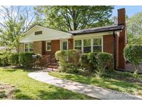 Charming brick home with a well-manicured lawn and walkway leading to the front door at 2721 Albany Ln, Charlotte, NC 28205