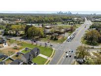 A vibrant aerial view shows the home's location near major intersections and Charlotte's skyline in the background at 3804 Freedom Dr, Charlotte, NC 28208