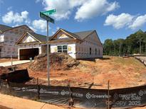 New construction home with visible protective wrap on exterior and yard under construction at 5602 Skinny Dr, Charlotte, NC 28215