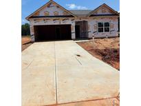 Unfinished home with a large driveway and two-car garage, awaiting personalization at 5602 Skinny Dr, Charlotte, NC 28215