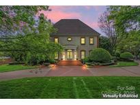 Stately home with a brick driveway, manicured landscaping, and a classic facade at 8934 Winged Bourne Dr, Charlotte, NC 28210