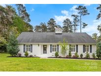 Charming one-story home with a lush green lawn and manicured landscaping at 103 Colonel Richard Rankin Dr, Stanley, NC 28164